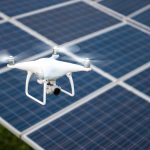 Drones and solar cells, The drone is a high angle camera shooting a solar cell farm. Which is clean energy Able to generate electricity